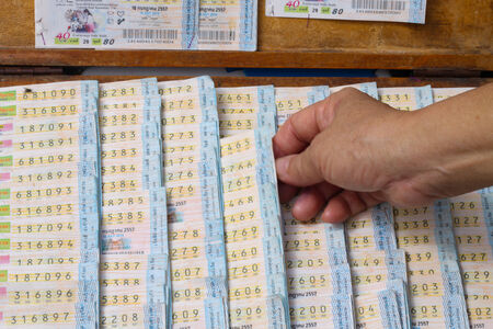 The man is buying Thai tradition lotteryのeditorial素材