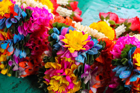 colorful flower garland on the green floorの写真素材