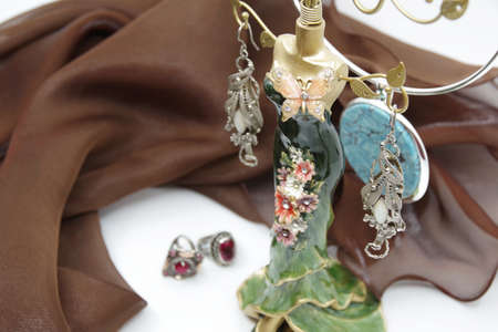 Beautiful jewelery close-up. Earrings, neck less and rings on the table. A collection of jewelry. Jewelry holderの写真素材