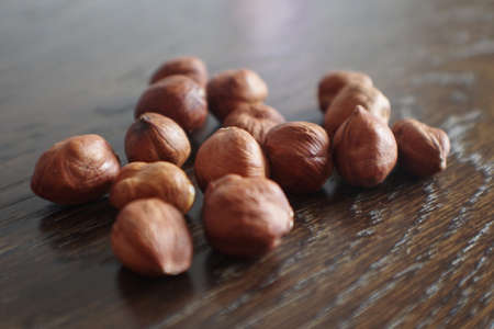 Heap of peeled hazelnuts. Hazel nuts. Organic peeled hazelnuts on Wooden Background.の写真素材