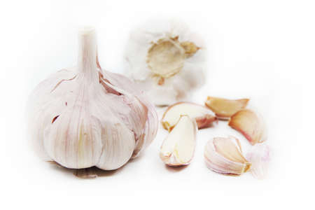 Organic garlic. Fresh garlic cloves and garlic bulb isolated on a white background. Garlic for healthy eating. Closeupの写真素材