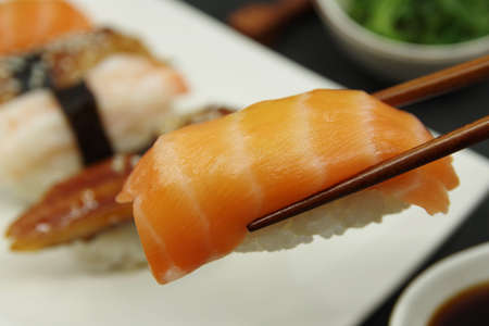 Japanese cuisine: Salmon Nigiri, Unagi nigiri, Shrimp Nigiri. Wooden sushi sticksの写真素材
