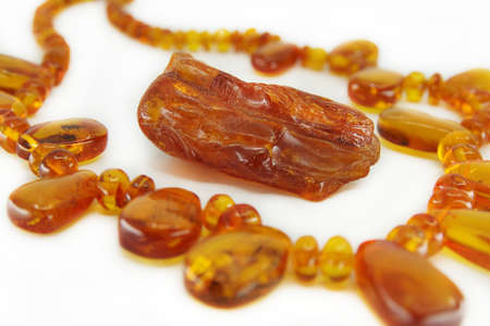 Necklace made of Baltic amber isolated on a white background. Piece of yellow translucent natural amber in the middle. Beautiful jevelry for womanの写真素材