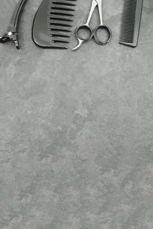 Hairdresser tools isolated on gray background with copy space for your text. Scissor, comb and hairpins.の写真素材