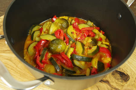 Vegetable curry in a black pot on the table. Vegetarian Curry. Closeupの写真素材