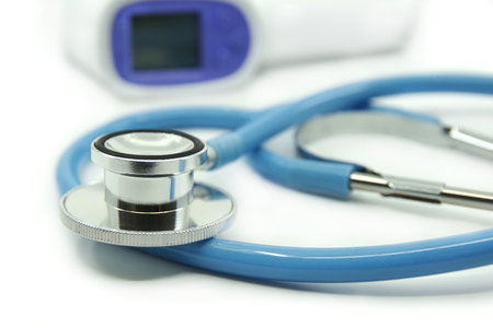 Blue stethoscope and infrared thermometer on white background. Medical devices For treatment. Healthcare concept.の写真素材