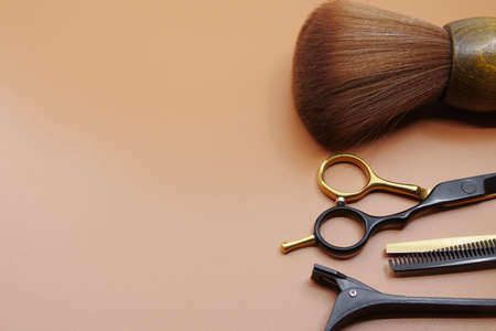 Hairdressers tools isolated on brown background with copy space for your text. Hairdressers scissor and hairpins.の写真素材