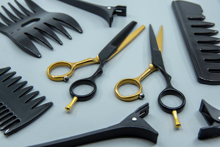 Professional hairdressers tools isolated on brown background. Hairdressers scissor, comb and hairpins.の写真素材