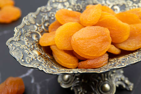 Delicious and healthy dried apricots in ceramic bowls. Healthy food concept. Top view.