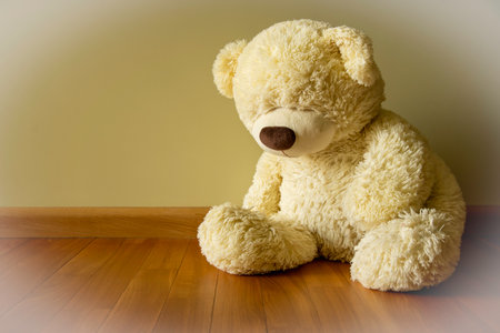 Sad Teddy bear sitting alone on the floor Loneliness and Child abuse concept.の写真素材