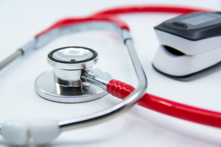 Stethoscope and Pulse Oximeter isolated on white background. Pulse Rate Health Tester is used to measure air in lungs. Covid-19, healthcare concept.の写真素材