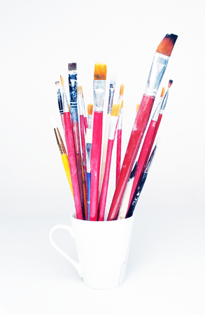 Paint brushes  in cup isolated on whiteの写真素材