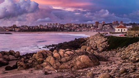Porto cityscape as seen from a rocky beach.の写真素材