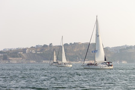 Three sailboats pass by in the river.のeditorial素材