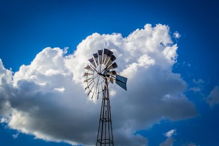 windmill wind vane and blue skyの写真素材