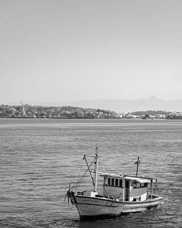 Rio de Janeiro, Brazil - CIRCA 2021: Fishing boat surrounded by seabirds during the day in Guanabara Bay, Rio de Janeiro, Southeastern Brazilのeditorial素材