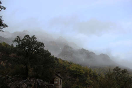 Photograph of an alpine landscape characterized by low-cook cloudsの写真素材