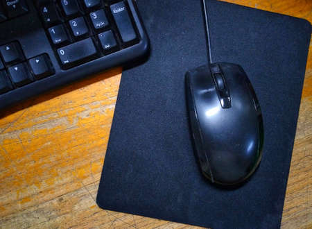 photo of mouse and computer device on work deskの写真素材