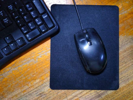 photo of mouse and computer device on work deskの写真素材