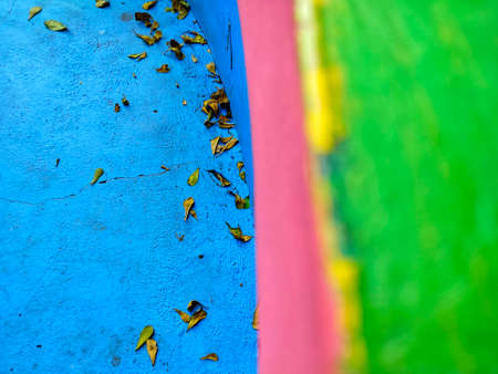 Colorful playground with fallen leaves on the floor. Selective focus.の写真素材