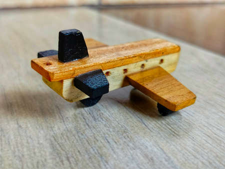 photo of a miniature airplane made of woodの写真素材