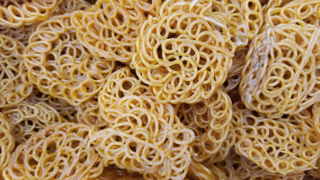 Photo of round yellow crackers used as background for editing