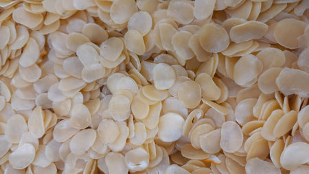 A photo of light brown circle shaped raw crackers is used as an editing background