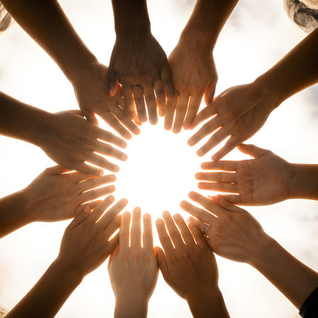 Group of people hands forming a circle in the sun. Concept of teamwork.の素材