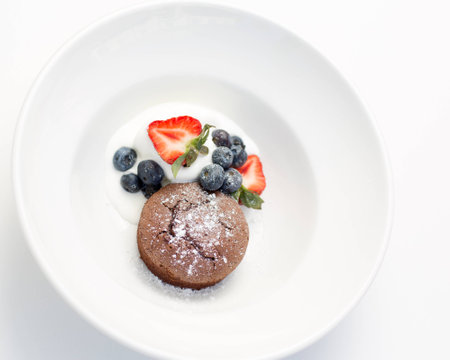 Chocolate fondant served with bilberries, strawberries and ice cream.の写真素材