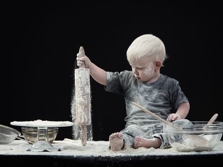 Loads of flour and one little happy boy.の写真素材