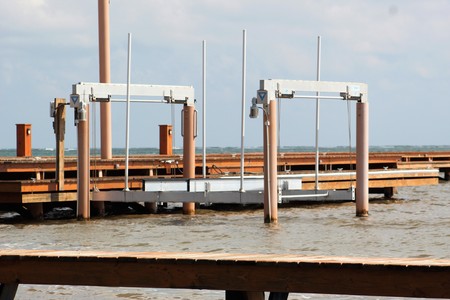 Large Metal Boat lift on calm waterの写真素材