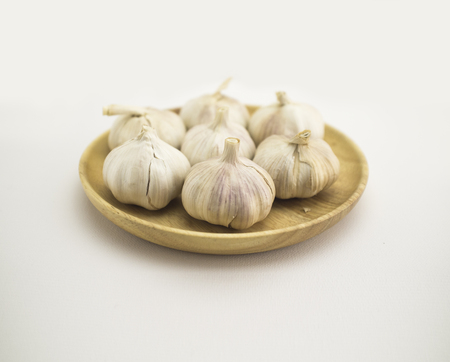 Garlic on a wooden platterの写真素材