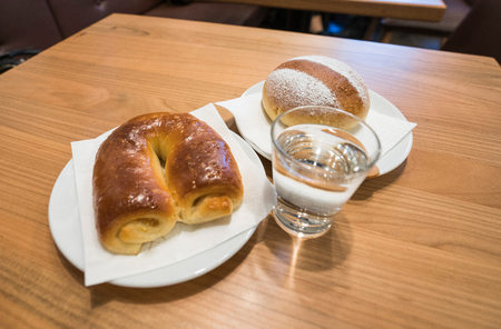 cake and coffee on a table with a glass of waterの写真素材