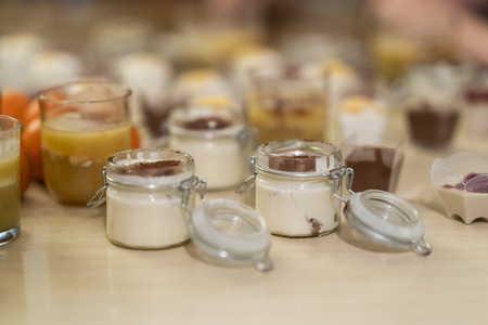 sweet and tasty deserts tiramisu, made out of coffee and mascarpone in a closeable glass on a tableの写真素材