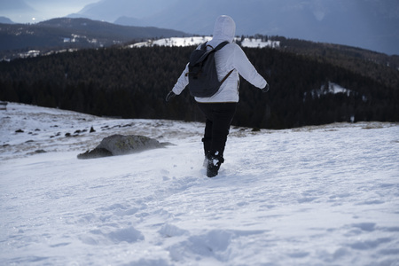Women hiking through snow in a snowy winter landscape in south tyrol