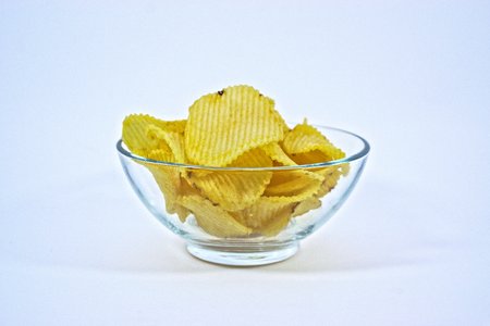 Crinkle cut potato chips in a bowlの写真素材