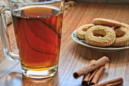 Tea and bidcuits on a wooden tableの写真素材