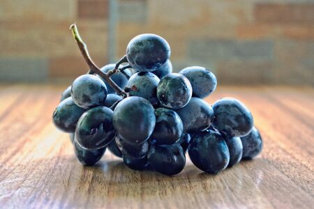 Grapes on a wooden tableの写真素材