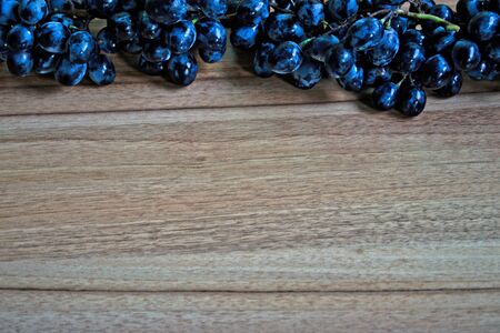 Grapes on a wooden tableの写真素材
