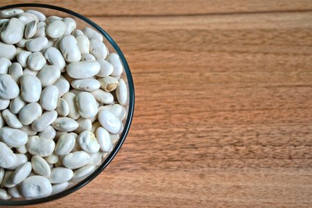 White beans in a bowl on a wooden tableの写真素材