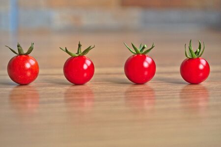 Closeup of ripe cherry tomatoes on a wooden tableの写真素材