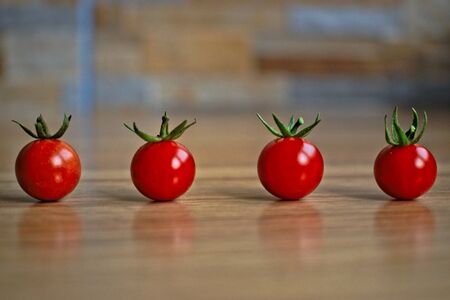 Closeup of ripe cherry tomatoes on a wooden tableの写真素材