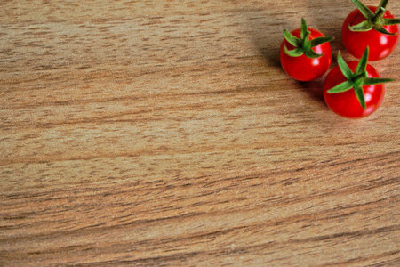 Closeup of ripe cherry tomatoes on a wooden tableの写真素材