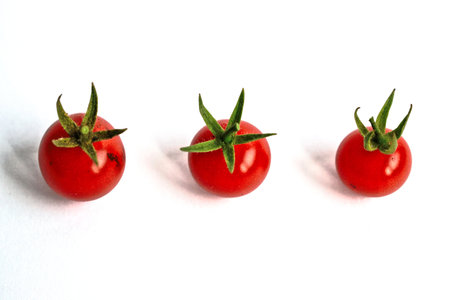 Closeup of ripe cherry tomatoes on a white backgroundの写真素材
