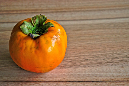 Persimmon on a wooden tableの写真素材