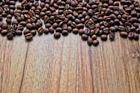 Coffee beans on a wooden table borderの写真素材
