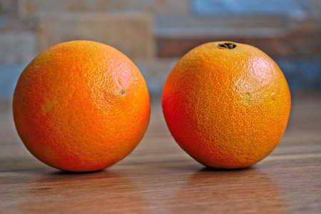 Two oranges on a wooden tableの写真素材