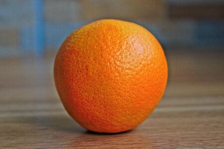 Orange on a wooden tableの写真素材