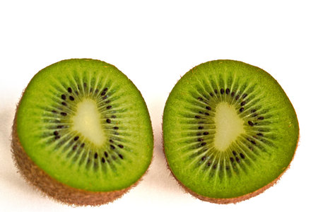 Closeup of two kiwi halves on a white backgroundの写真素材