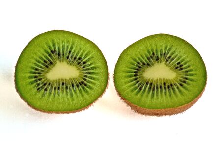 Closeup of two kiwi halves on a white backgroundの写真素材